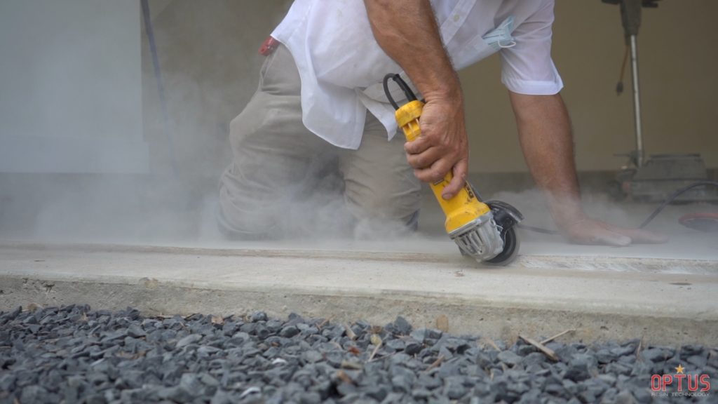man working on a surface preparing for a product application