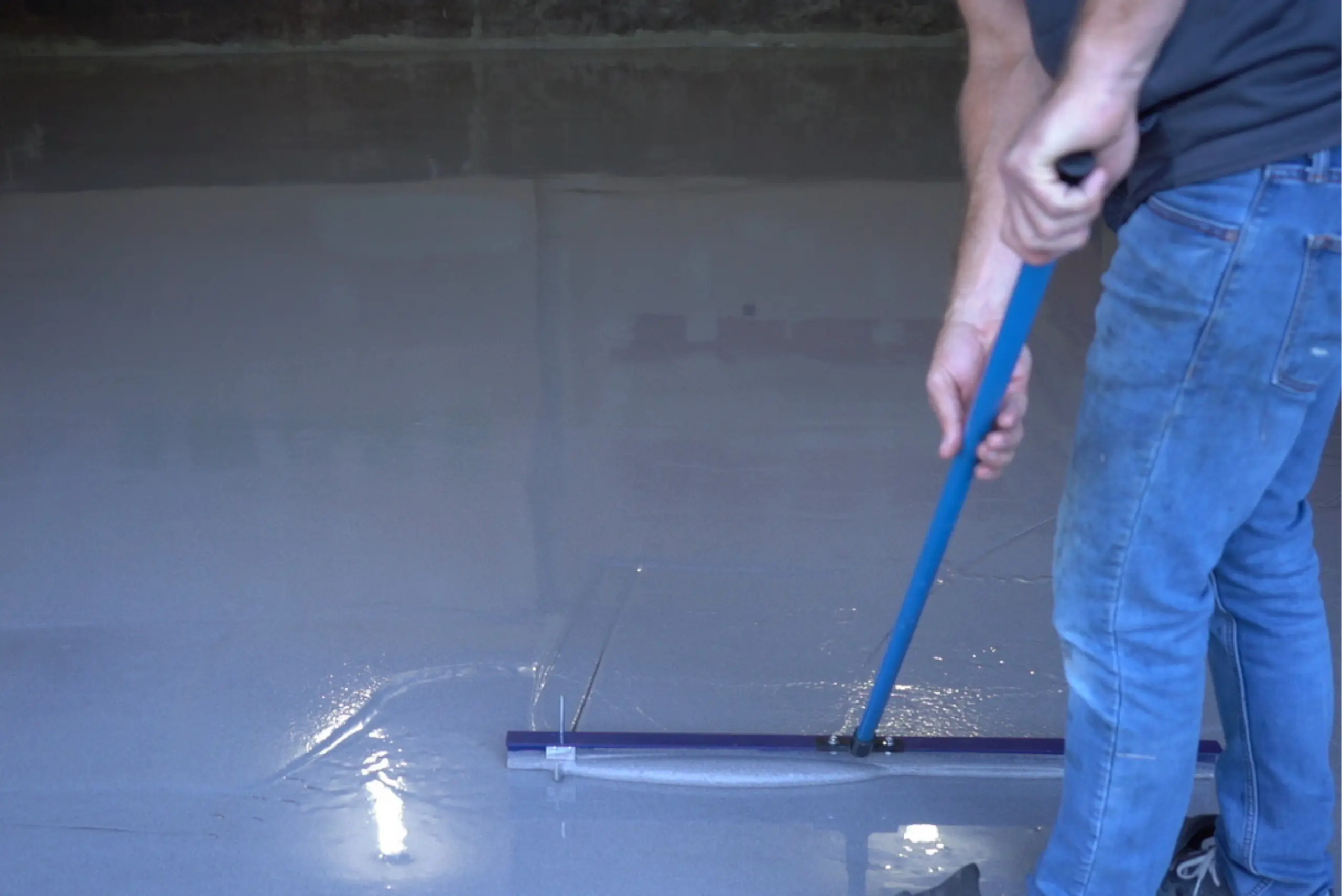 man applying a floaterra coating on a floor