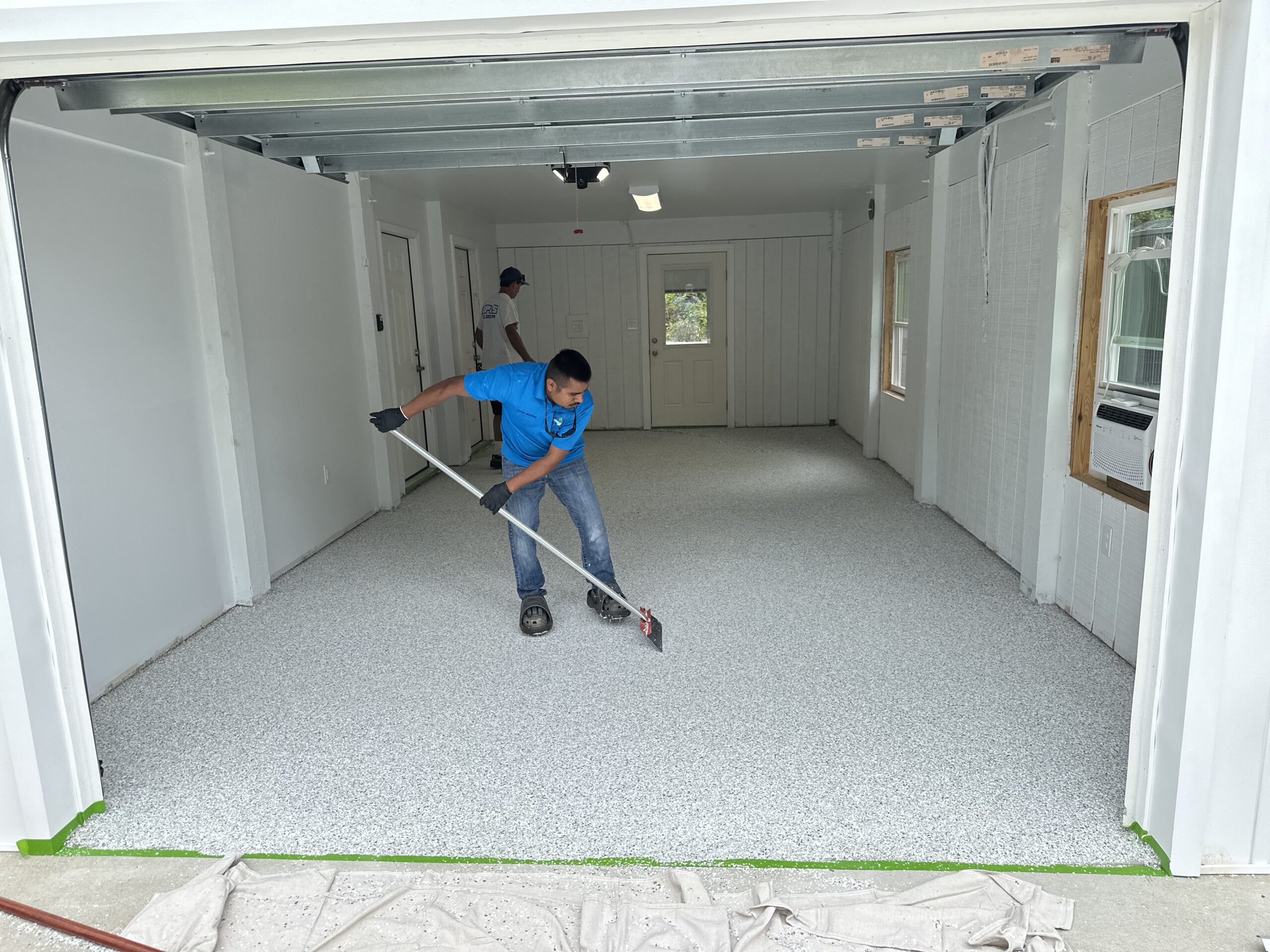 man working on a garage floor